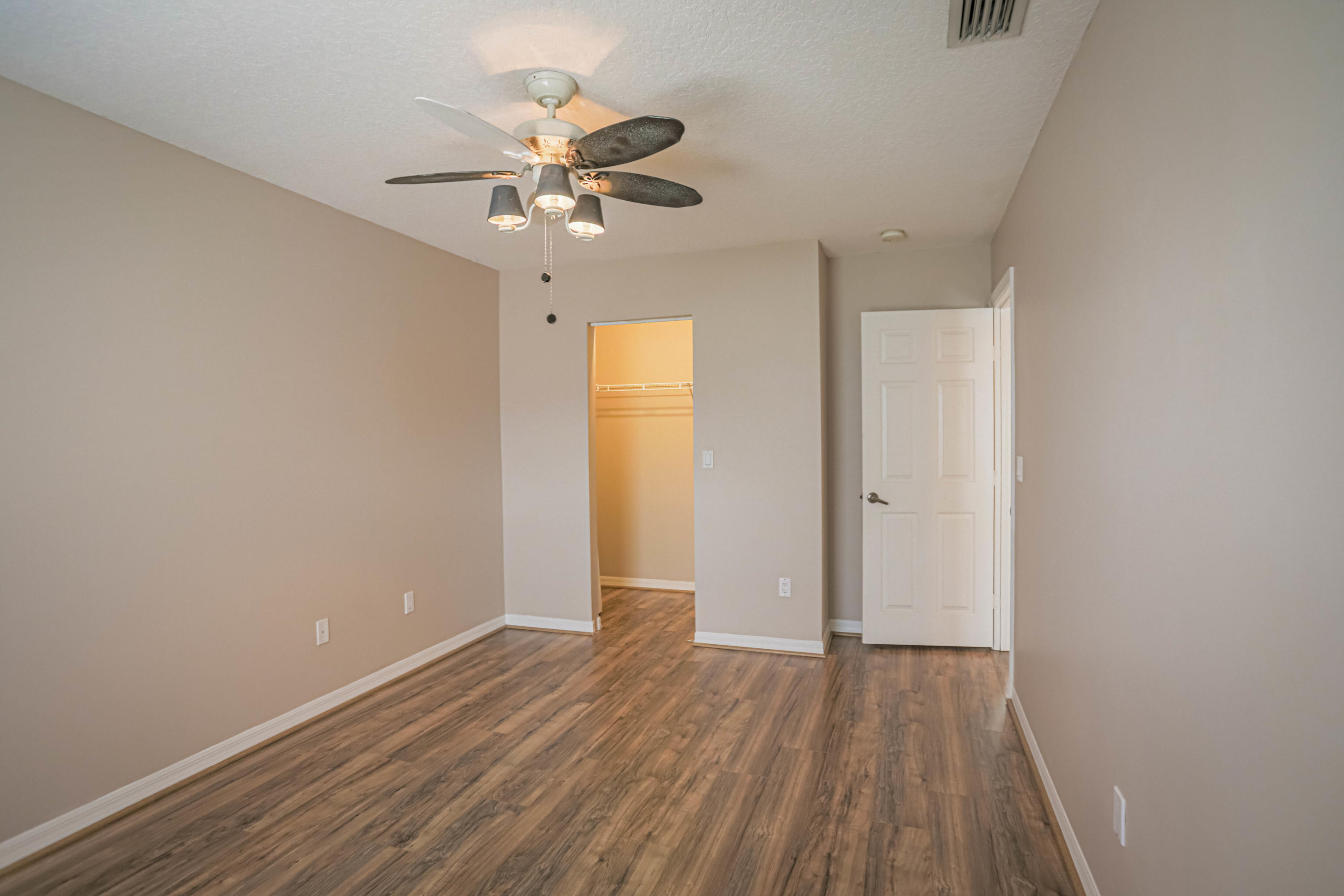 5218 Edenwood Road Riviera Beach, FL 33418 - Photo 19 of 31 wooden floor in an empty room with a window