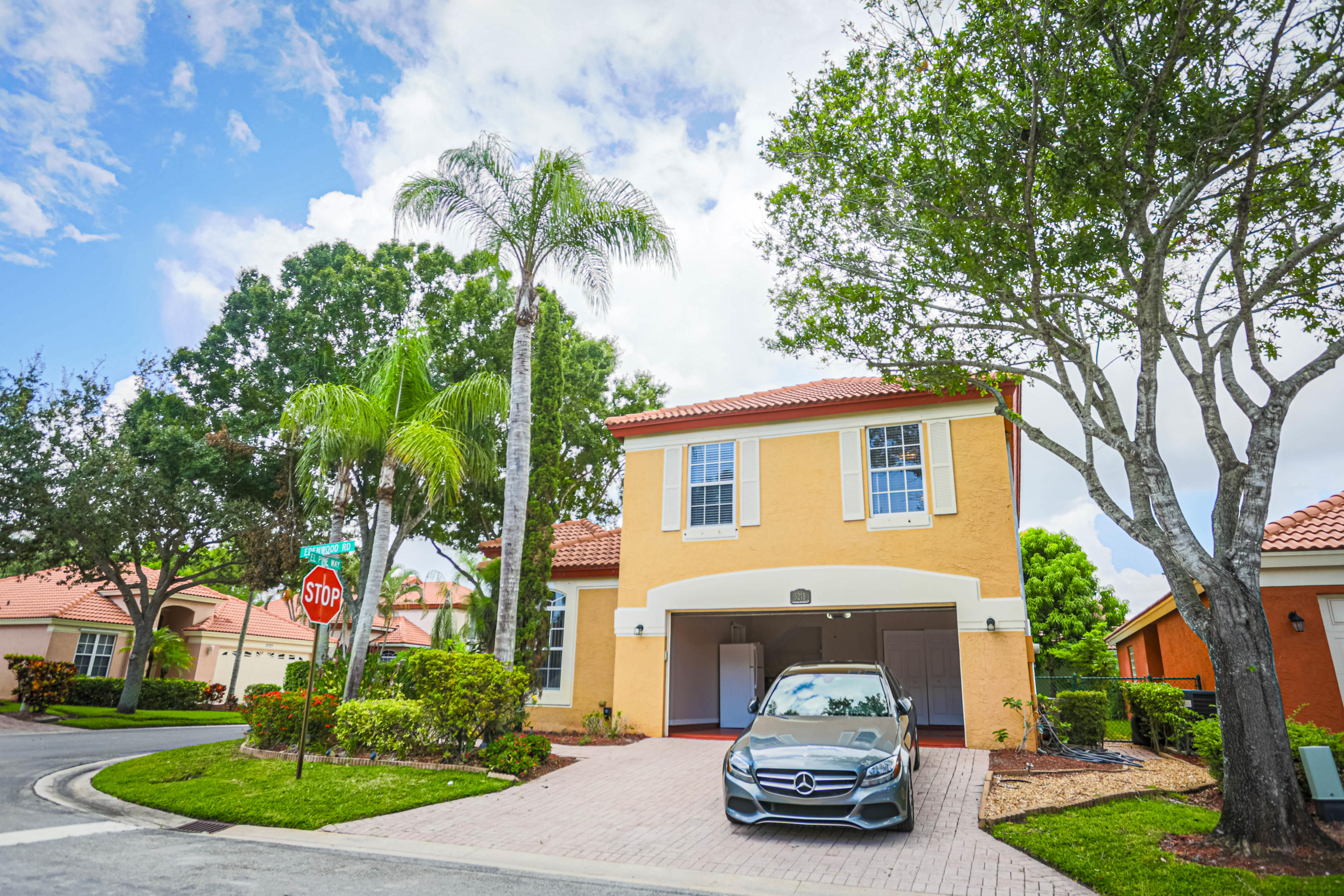 5218 Edenwood Road Riviera Beach, FL 33418 - Photo 2 of 31 a car parked in front of a white house