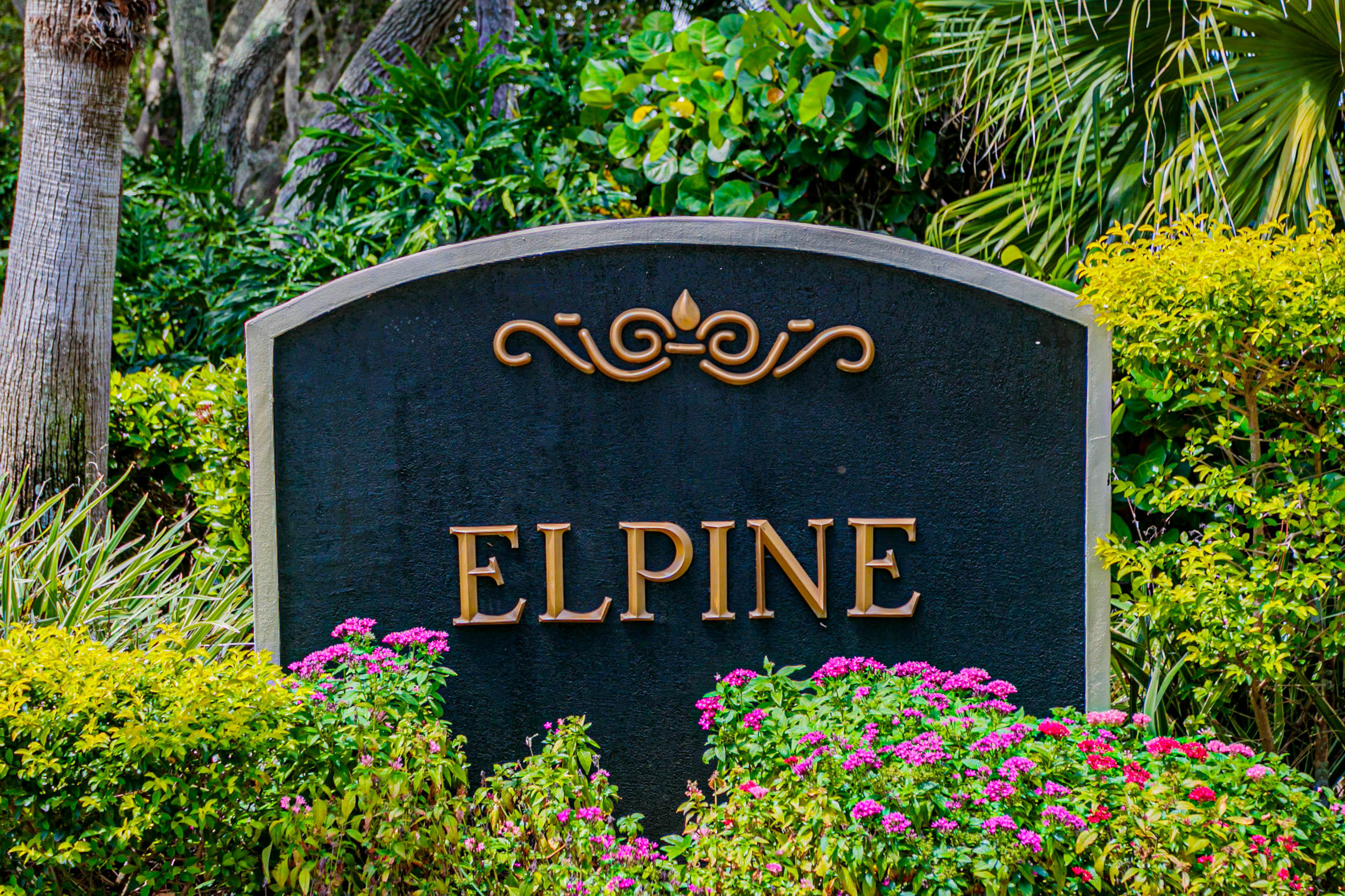 5218 Edenwood Road Riviera Beach, FL 33418 - Photo 24 of 31 a sign that is in front of flowers