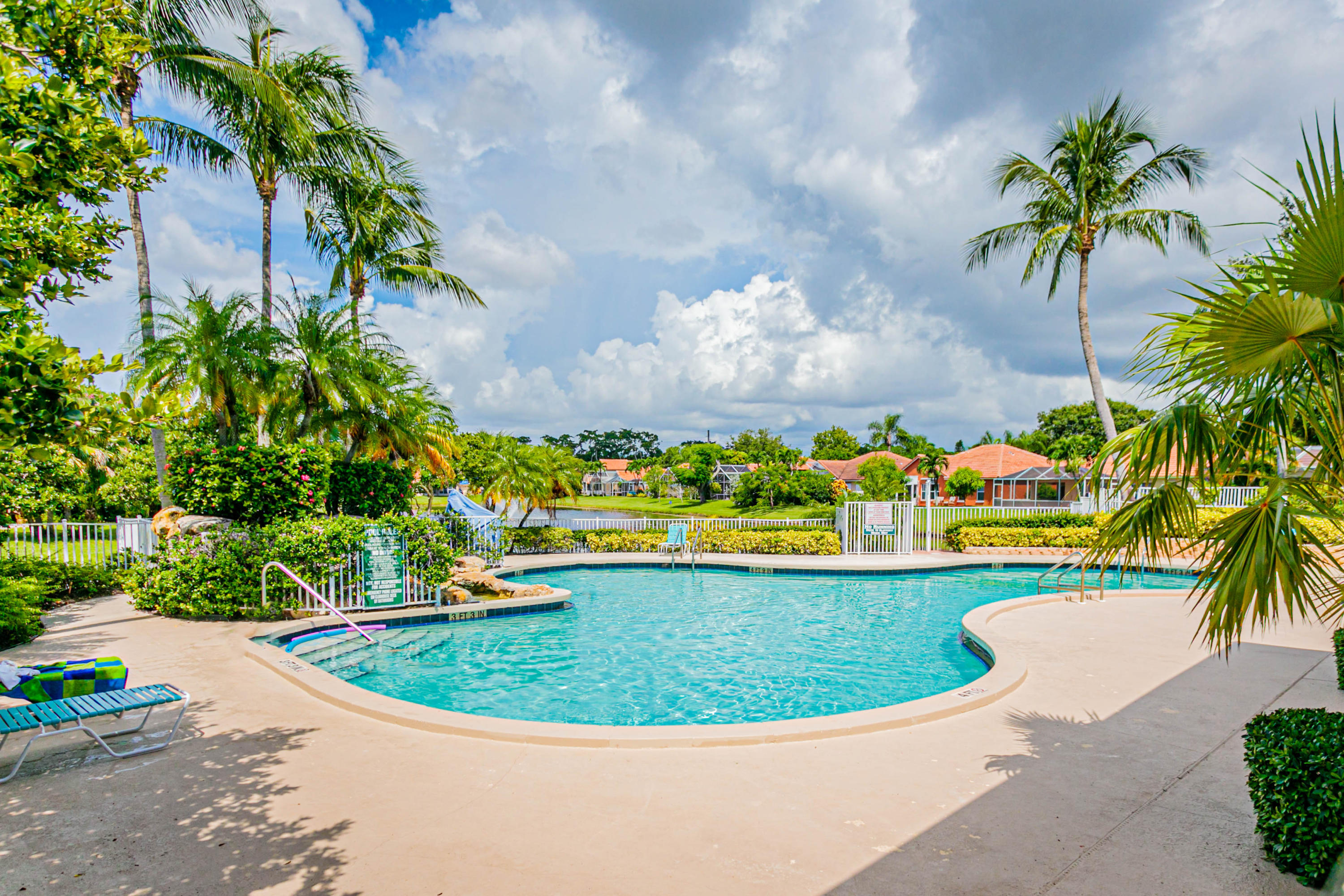 5218 Edenwood Road Riviera Beach, FL 33418 - Photo 27 of 31 a view of a swimming pool with a garden in the background