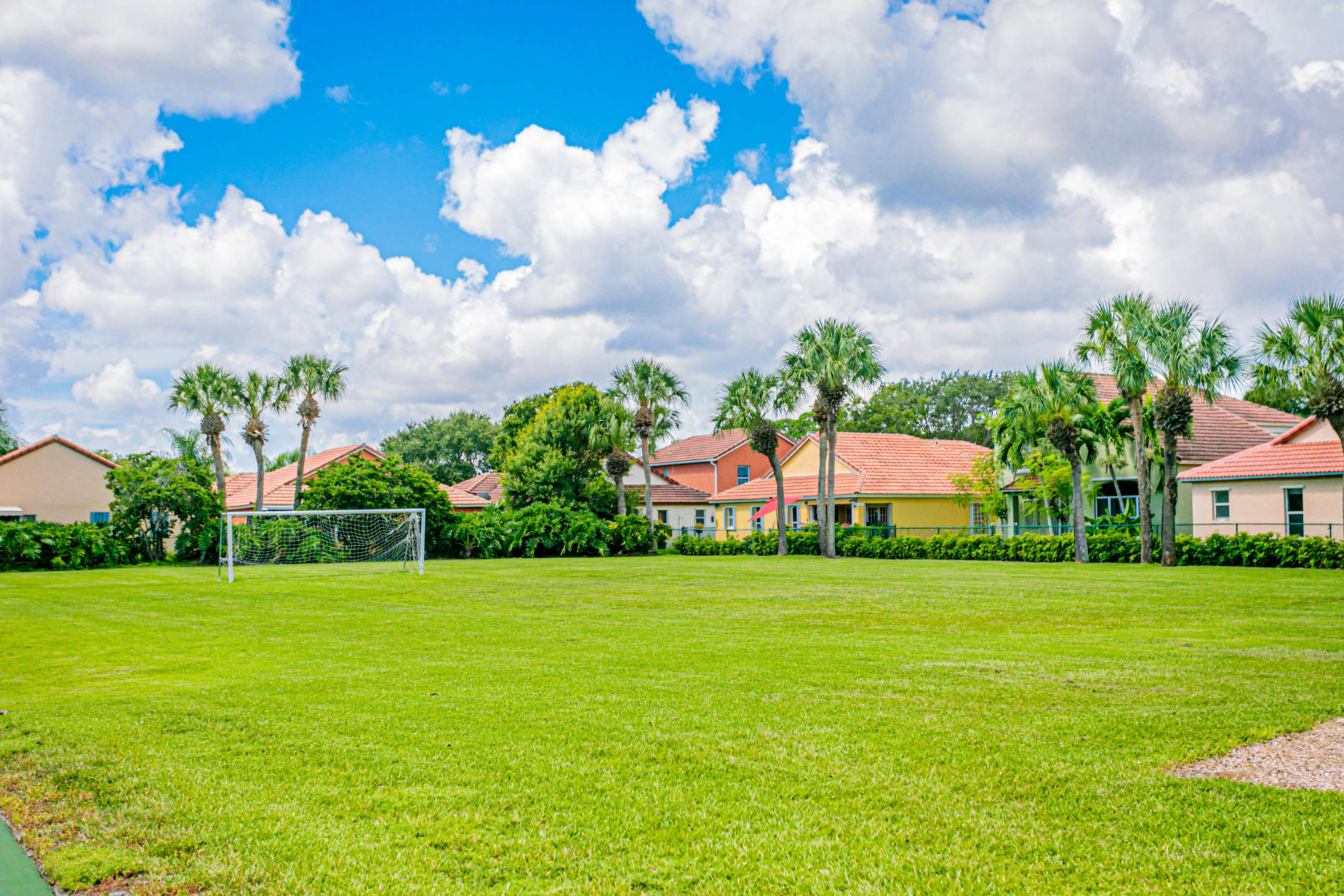 5218 Edenwood Road Riviera Beach, FL 33418 - Photo 29 of 31 a view of a white house with a big yard and potted plants