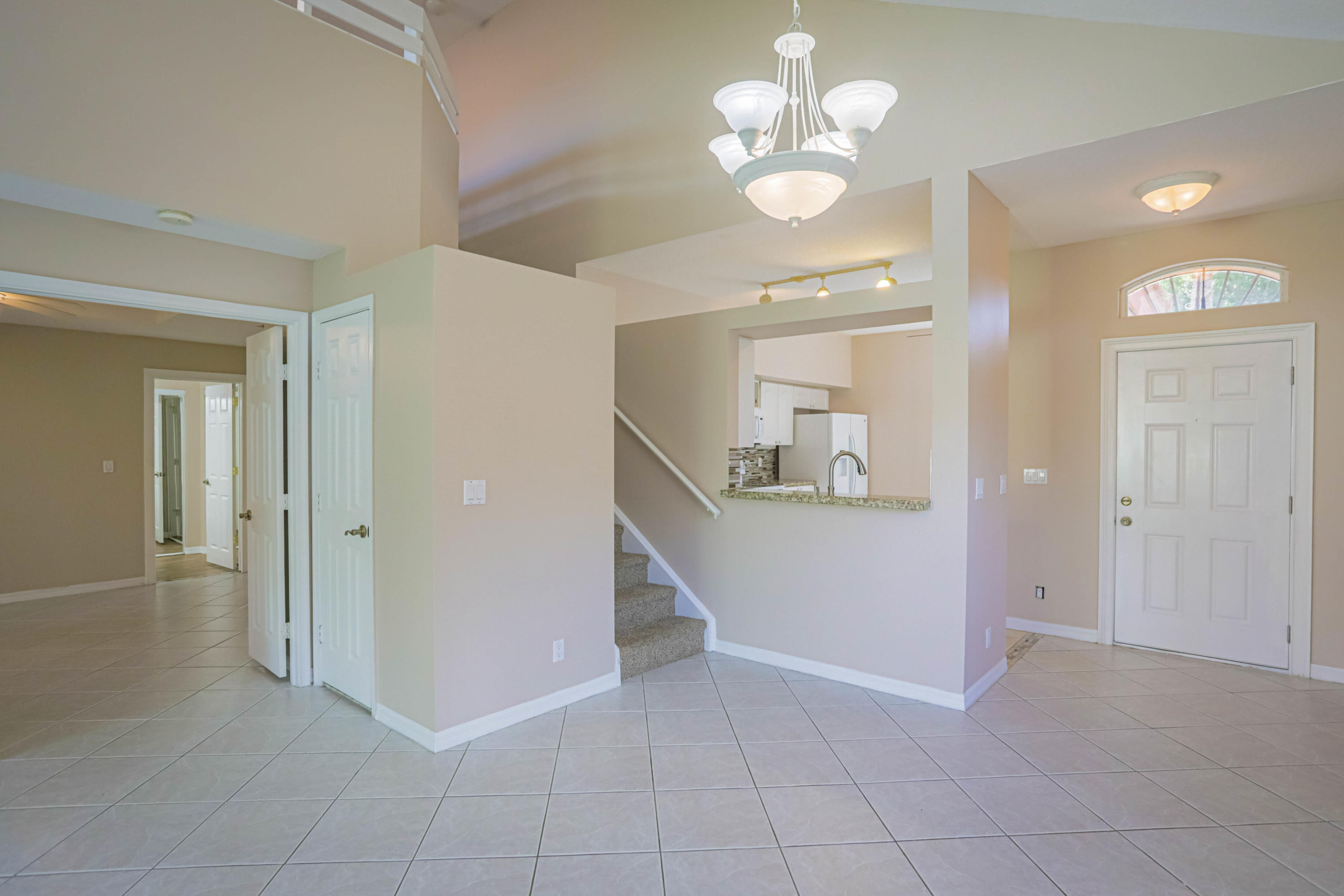5218 Edenwood Road Riviera Beach, FL 33418 - Photo 3 of 31 wooden floor in an empty room with a mirror