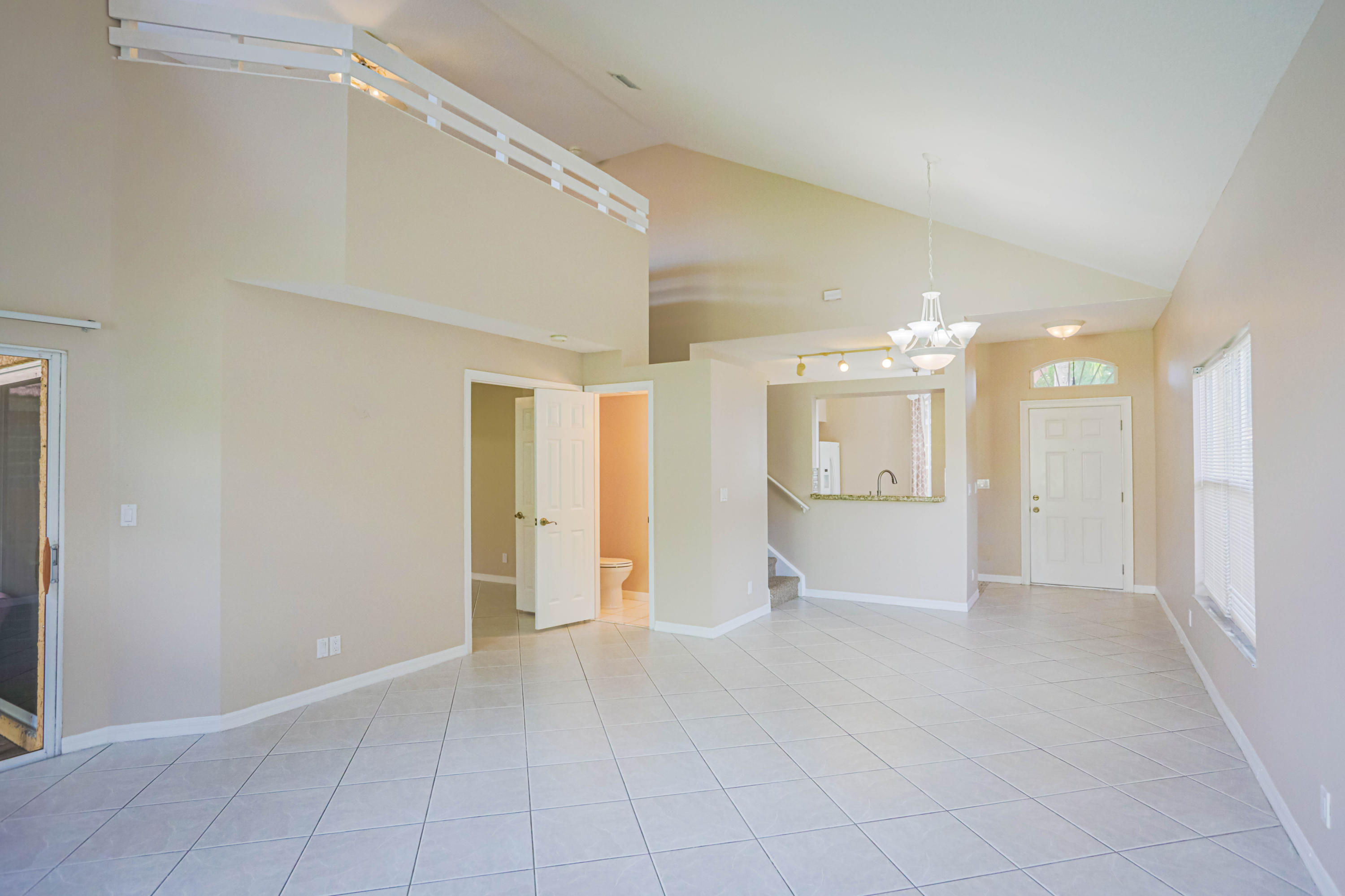 5218 Edenwood Road Riviera Beach, FL 33418 - Photo 4 of 31 a view of a big room with a chandelier fan and refrigerator