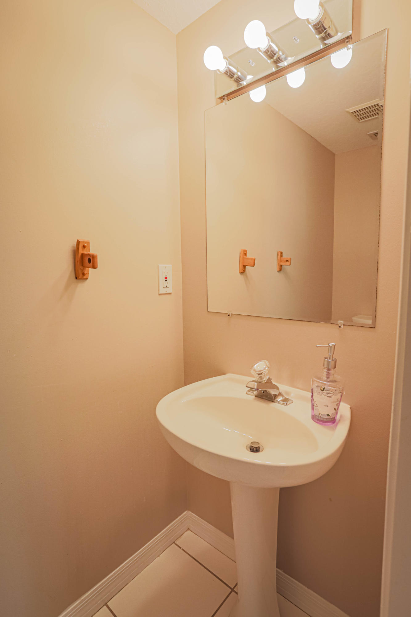 5218 Edenwood Road Riviera Beach, FL 33418 - Photo 6 of 31 a bathroom with a sink and mirror