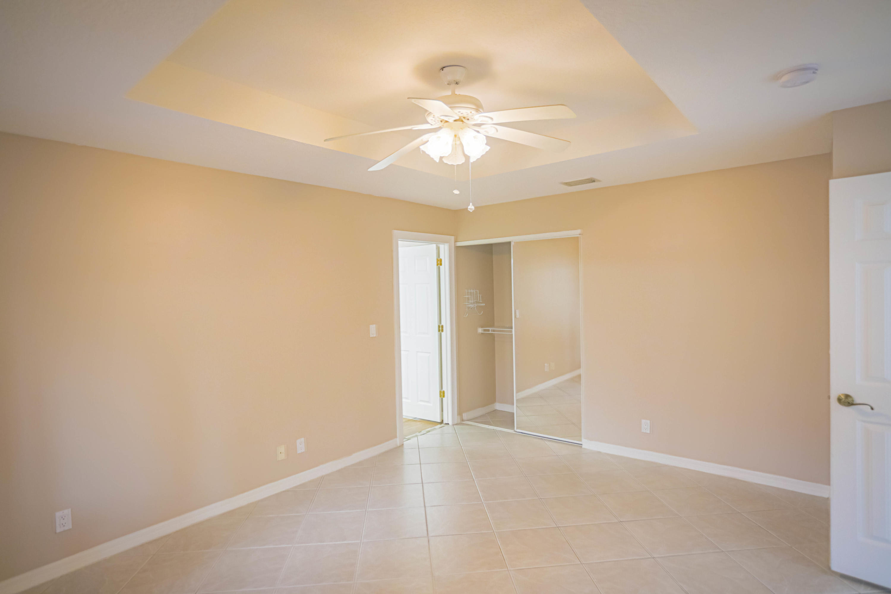 5218 Edenwood Road Riviera Beach, FL 33418 - Photo 8 of 31 an empty room with a ceiling fan and a window