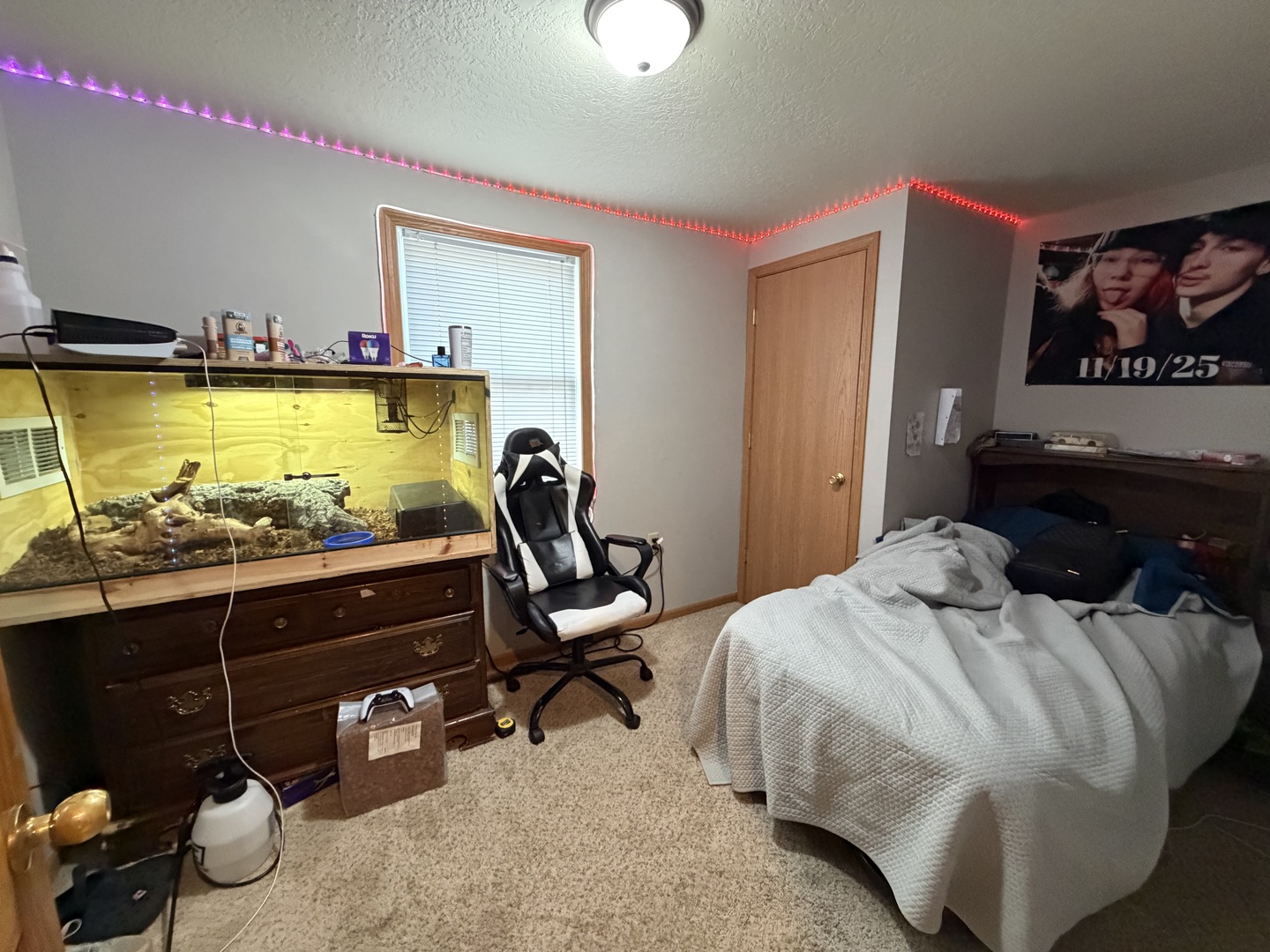 608 4th Avenue Sterling, IL 61081 - Photo 8 of 15 a bedroom with a bed and a chandelier