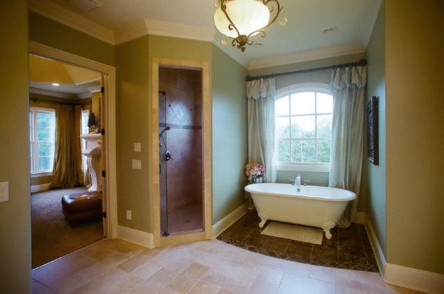 3239 Kinnard Springs Road Franklin, TN 37064 - Photo 8 of 20 Spacious master tub is a deep modern claw-foot tub sitting on chocolate marble in its own alcove. A full walk-in shower with his/her shower heads/controls, glass door, tiled floor to ceiling, and corner bench. Shower valves remember your temperature