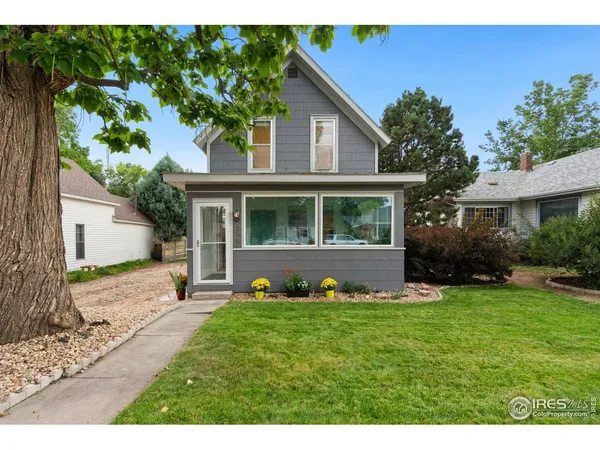 a front view of a house with a yard and porch