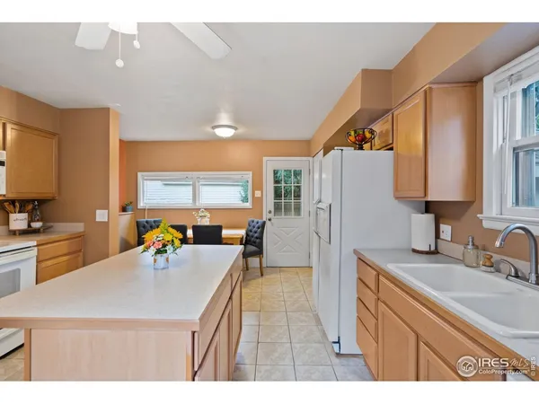 a kitchen with a sink a counter top space cabinets and stainless steel appliances