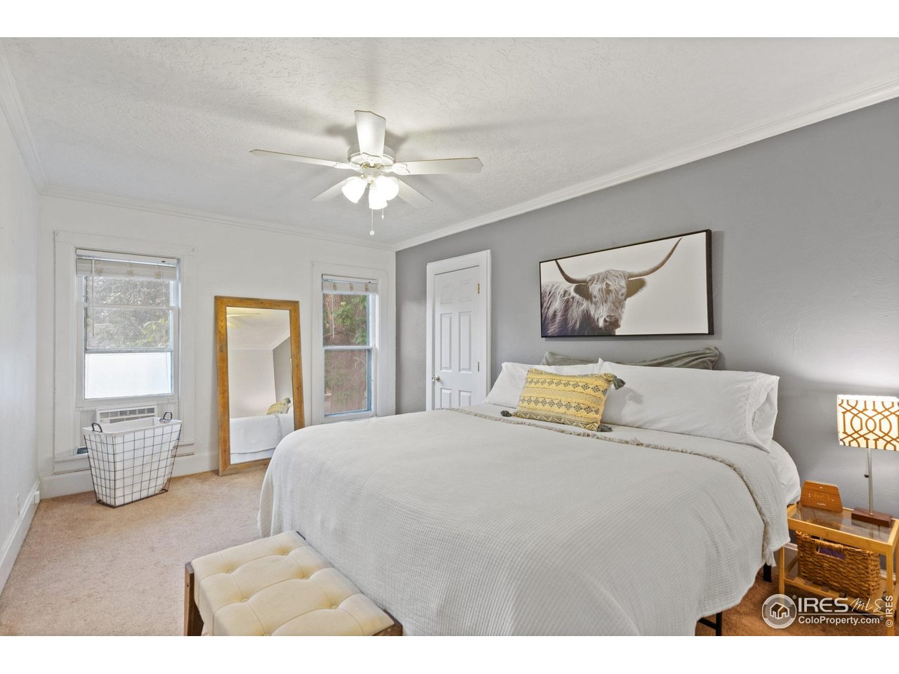 322 Maple Avenue Eaton, CO 80615 - Photo 10 of 26 a bedroom with a large bed and wooden floor