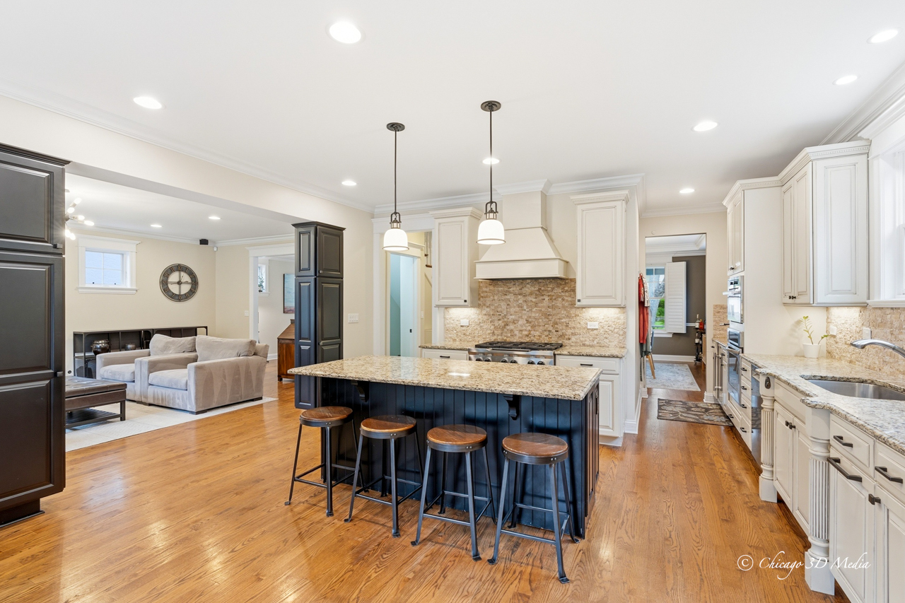 306 17th Street Wilmette, IL 60091 - Photo 14 of 48 a large kitchen with kitchen island a dining table chairs and a wooden floor