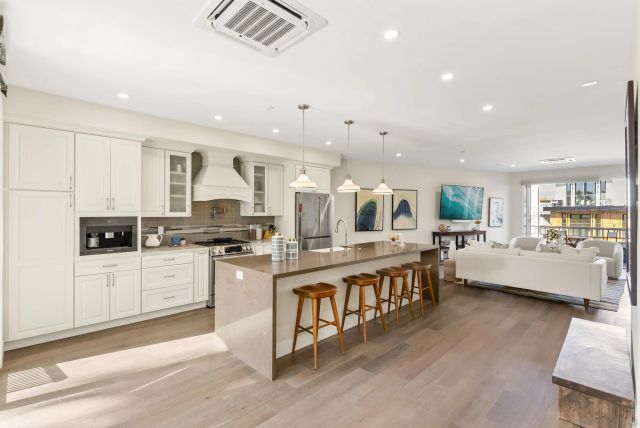 a dining room with chandelier a wooden table and chairs