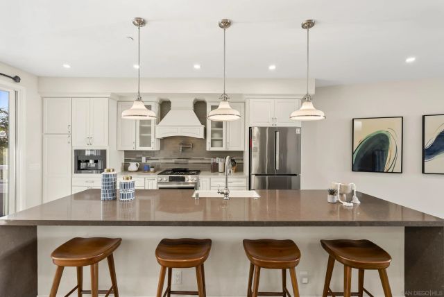a dining room with wooden floor and large windows