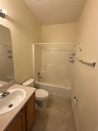 an empty room with a ceiling fan and window