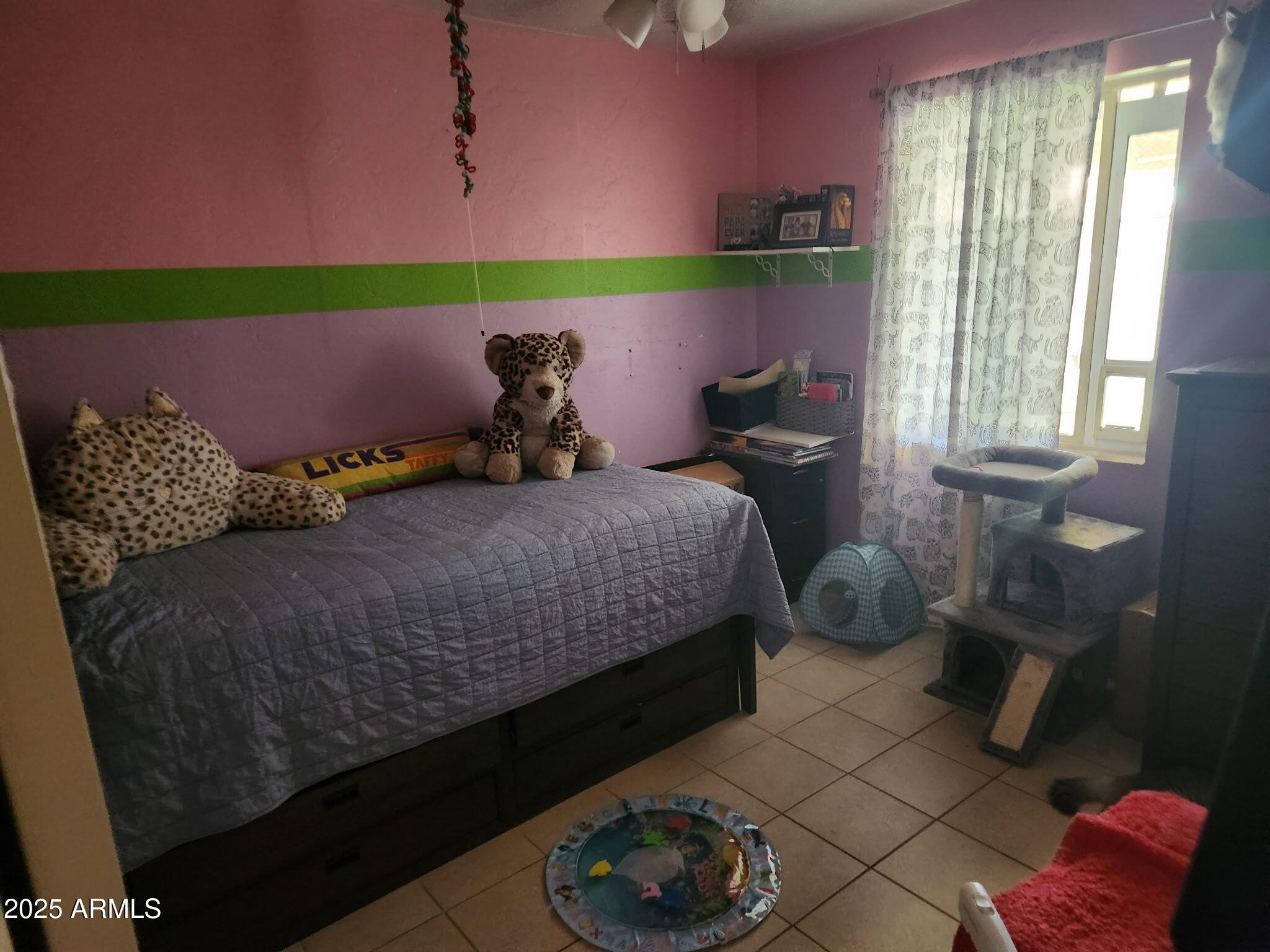 3039 East Cactus Road Phoenix, AZ 85028 - Photo 12 of 15 a bed sitting in a bedroom next to a window