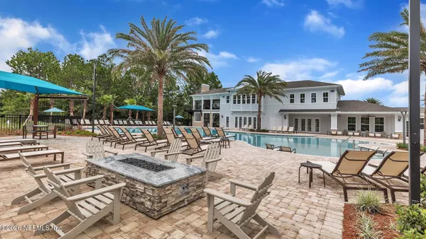 a swimming pool with outdoor seating and yard