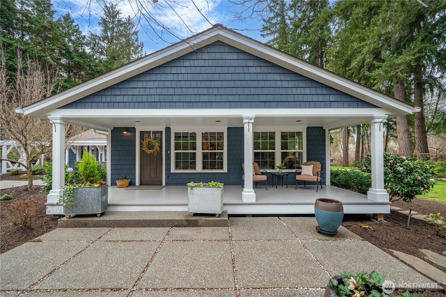 26002 Southeast 208th Street Maple Valley, WA 98038 - Photo 3 of 40 a front view of house with outdoor seating and green space