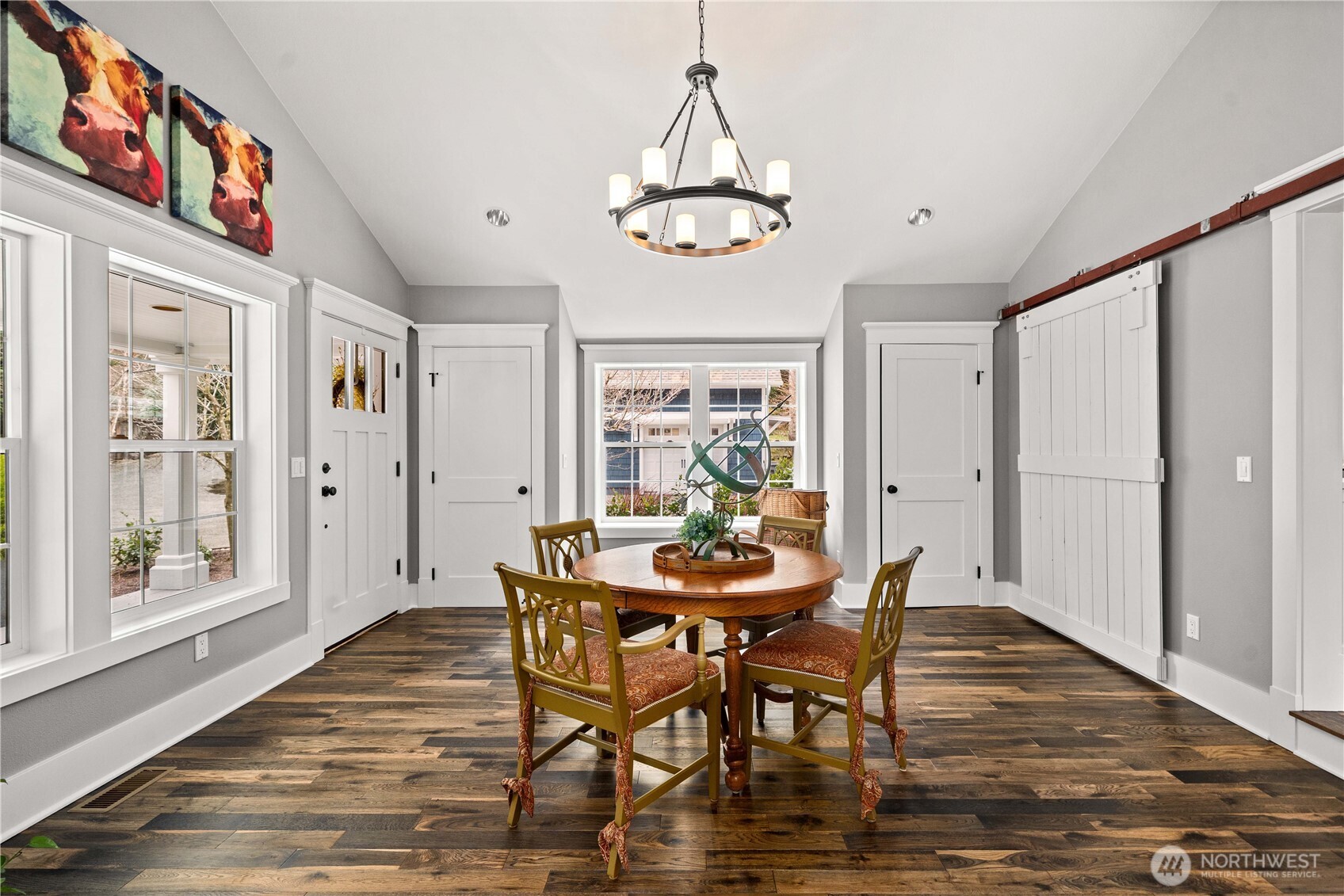 26002 Southeast 208th Street Maple Valley, WA 98038 - Photo 5 of 40 a dining room with furniture a chandelier and wooden floor