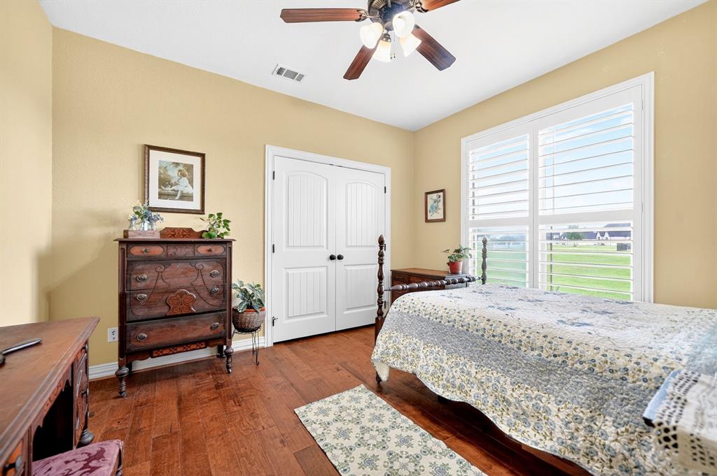 1399 Canyon Lake Road Wills Point, TX 75169 - Photo 20 of 37 a bedroom with a bed and wooden floor