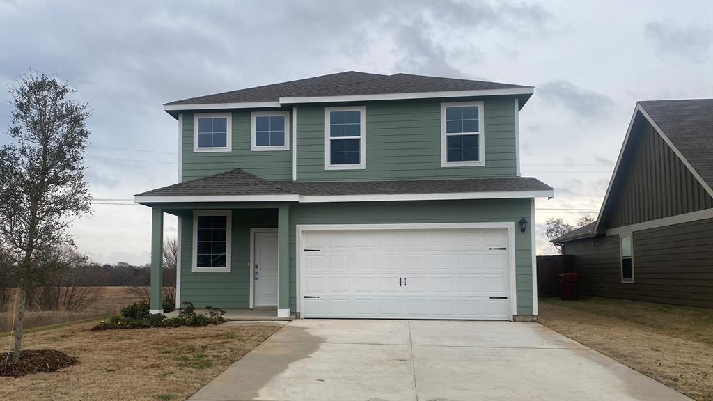 a front view of a house with garage