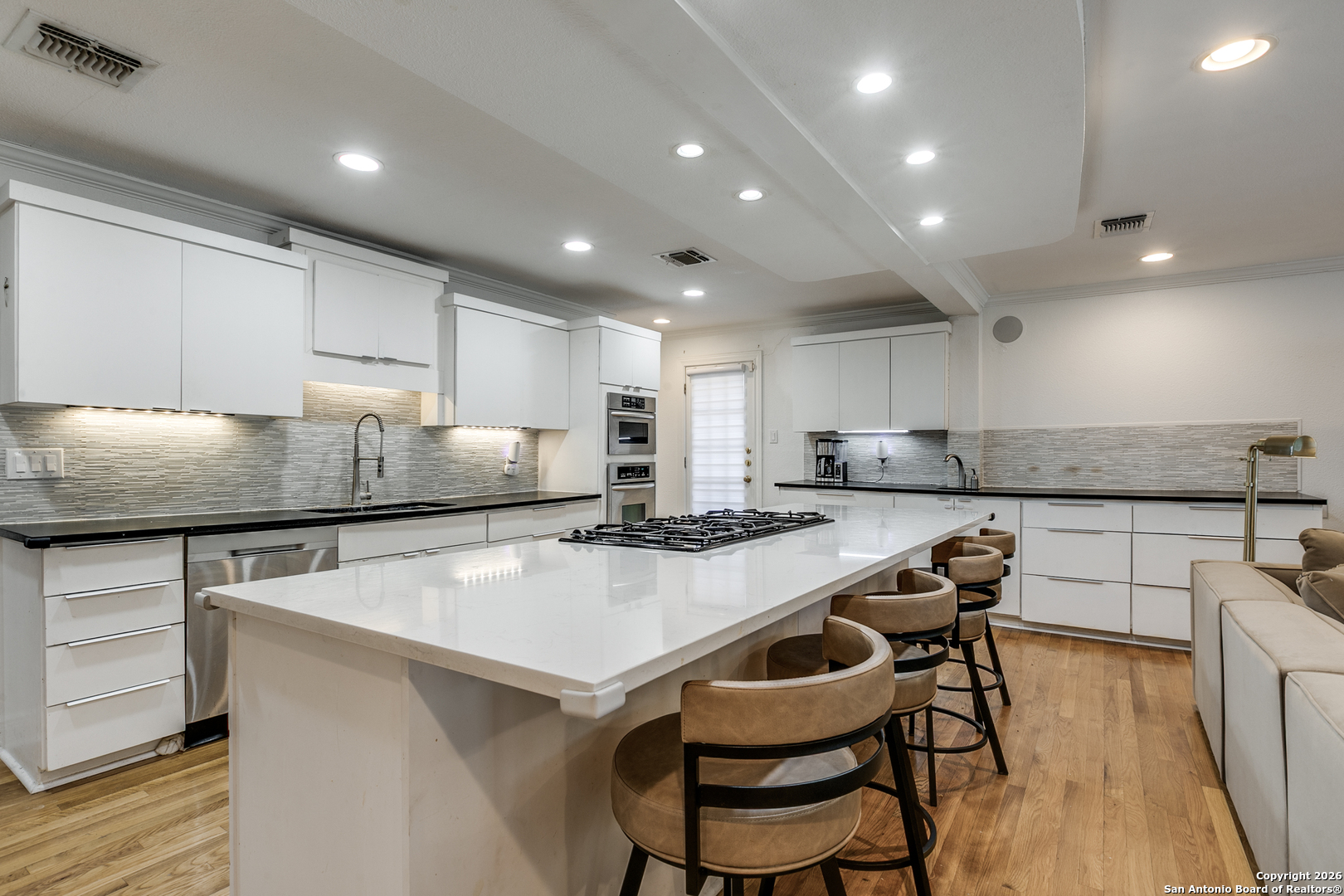 825 Garraty Road Terrell Hills, TX 78209 - Photo 11 of 25 a kitchen with kitchen island a stove a table and chairs in it