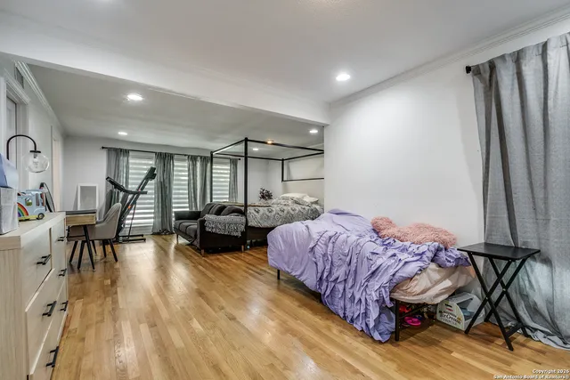 a living room with furniture a window and gym equipment