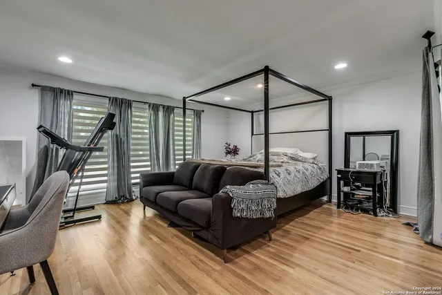 a bedroom with furniture and a wooden floor