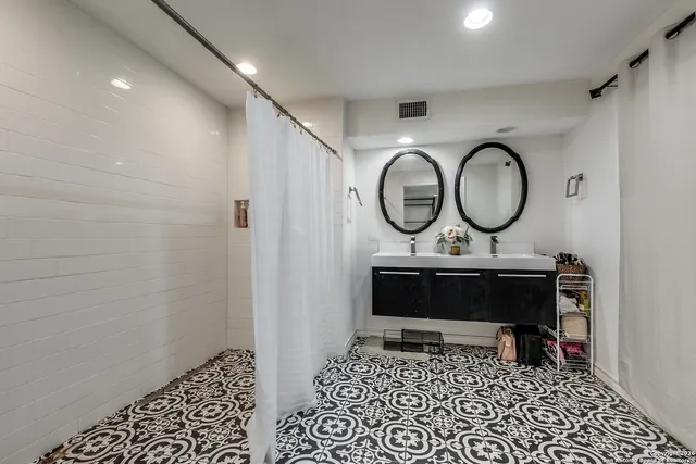 a living room with furniture a rug and a wall painting