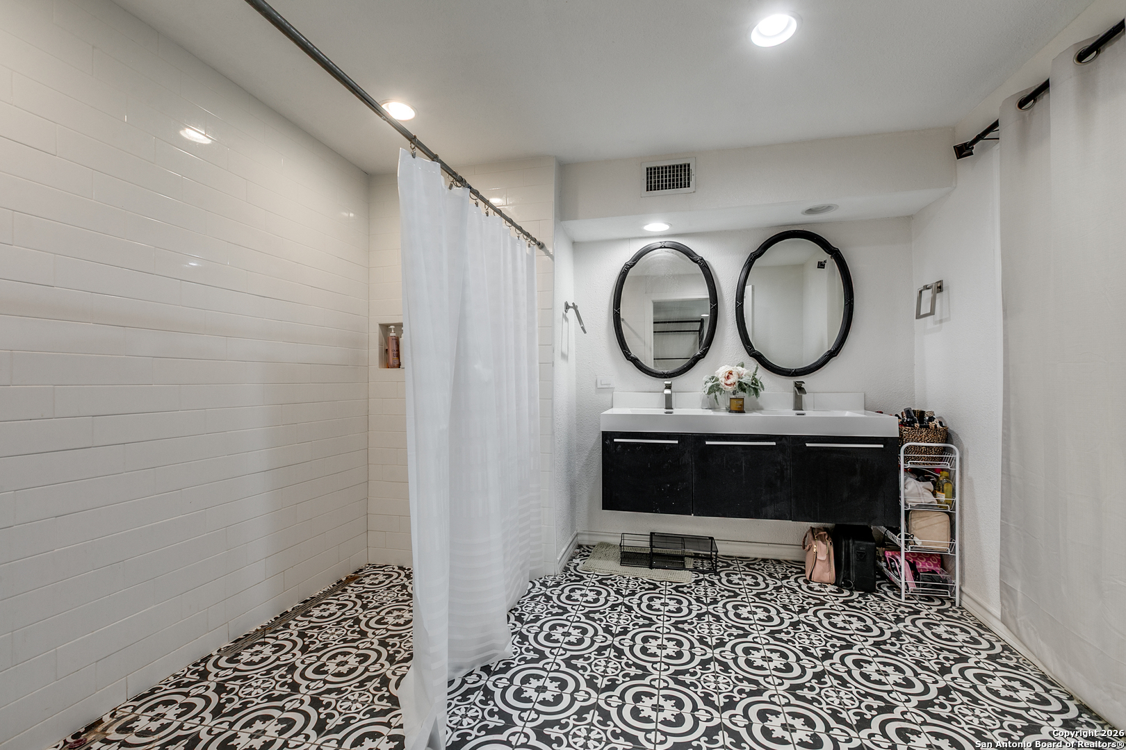 825 Garraty Road Terrell Hills, TX 78209 - Photo 16 of 25 a living room with furniture a rug and a wall painting