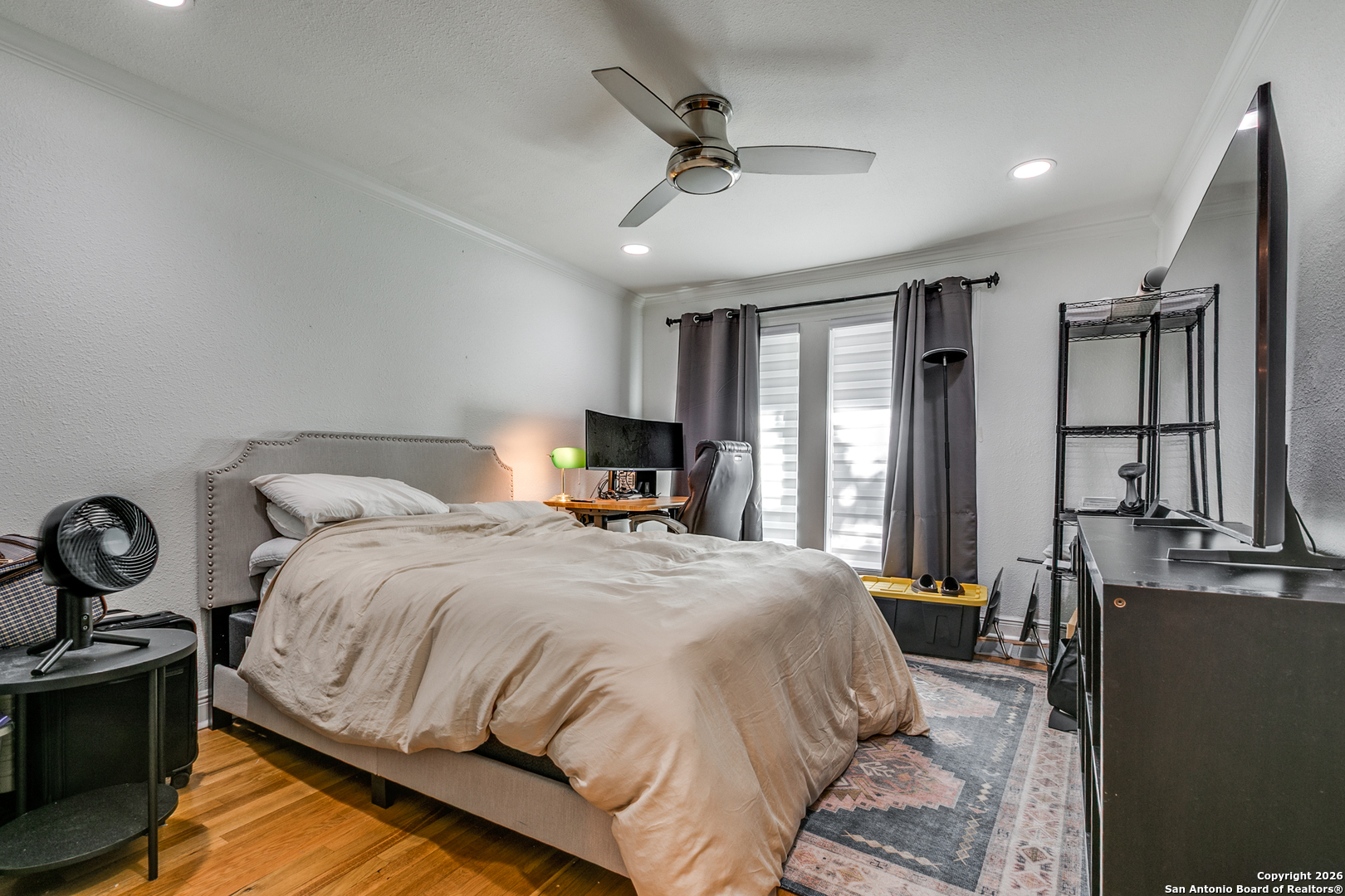 825 Garraty Road Terrell Hills, TX 78209 - Photo 17 of 25 a bedroom with a bed a flat screen tv and a large window