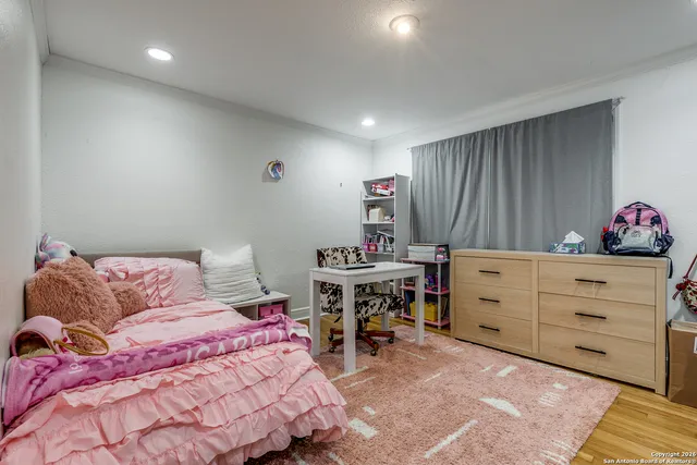 a bedroom with a bed and a dresser