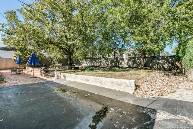 a view of a patio with table and chairs and potted plants