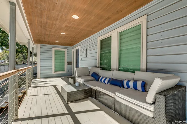a balcony with furniture and a potted plant