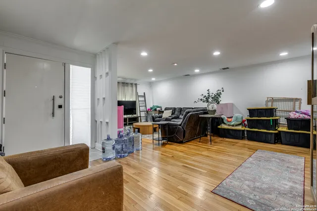 a living room with furniture a flat screen tv and kitchen view