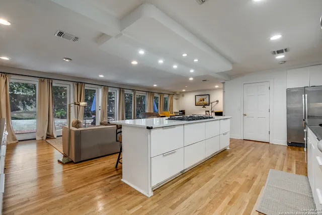 a kitchen with stainless steel appliances kitchen island wooden cabinets and granite counter tops