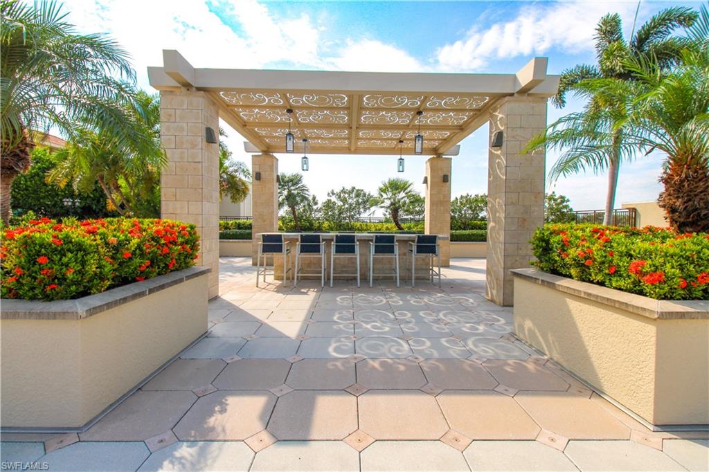 9123 Strada Place, Unit 7410 Naples, FL 34108 - Photo 9 of 50 View of patio / terrace with exterior bar and a pergola