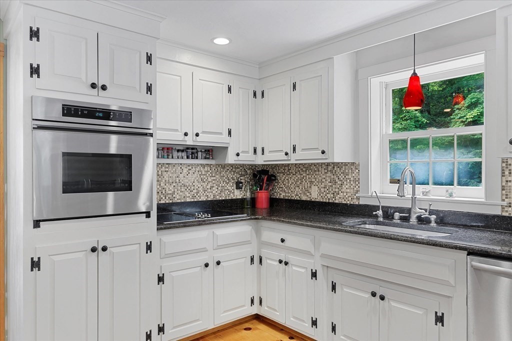 94 Stallion Hill Road Sturbridge, MA 01518 - Photo 11 of 42 a kitchen with granite countertop a stove a sink and a microwave