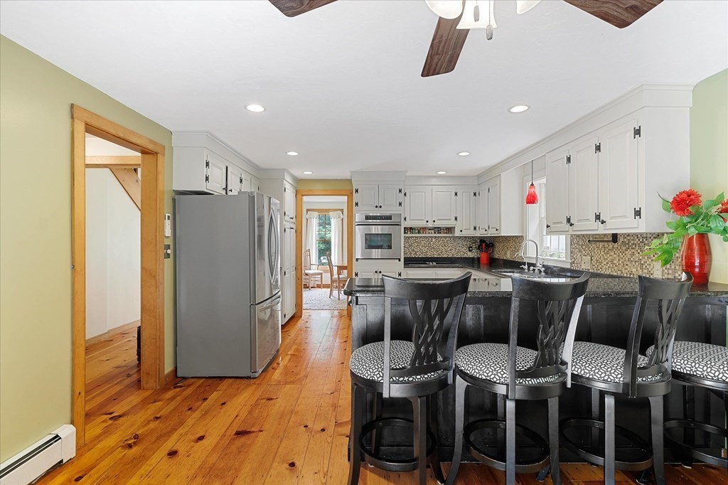 94 Stallion Hill Road Sturbridge, MA 01518 - Photo 12 of 42 a view of kitchen dining space and wooden floor