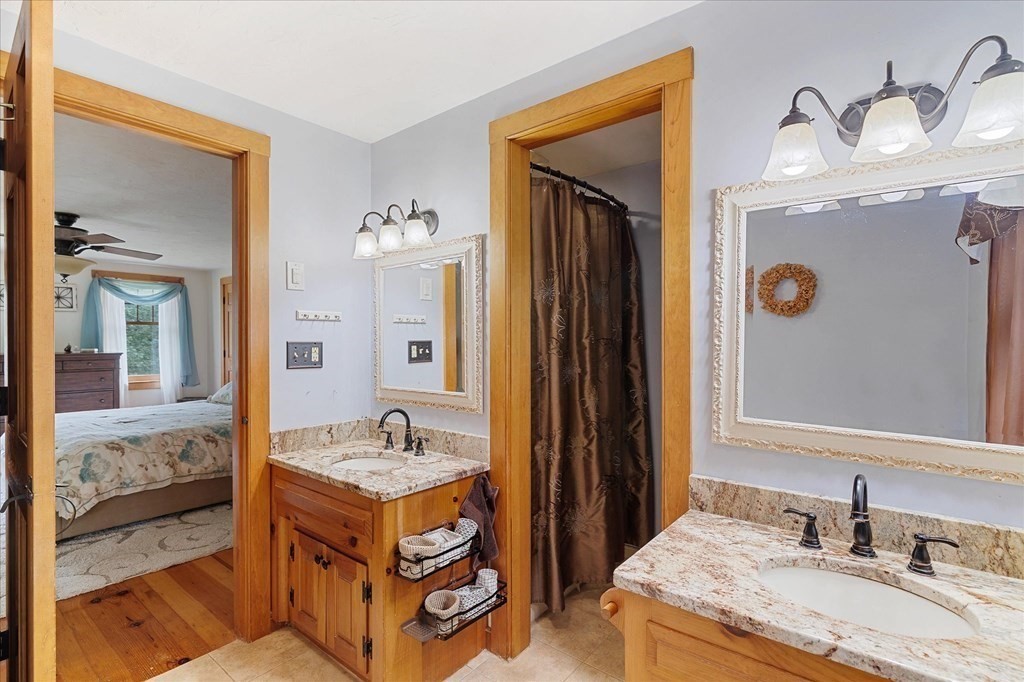 94 Stallion Hill Road Sturbridge, MA 01518 - Photo 24 of 42 a bathroom with a sink double vanity and a mirror