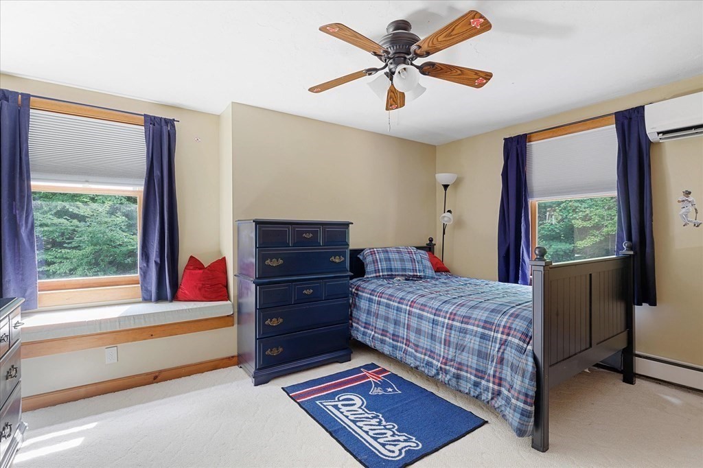 94 Stallion Hill Road Sturbridge, MA 01518 - Photo 28 of 42 a bedroom with a bed and a dresser next to a window