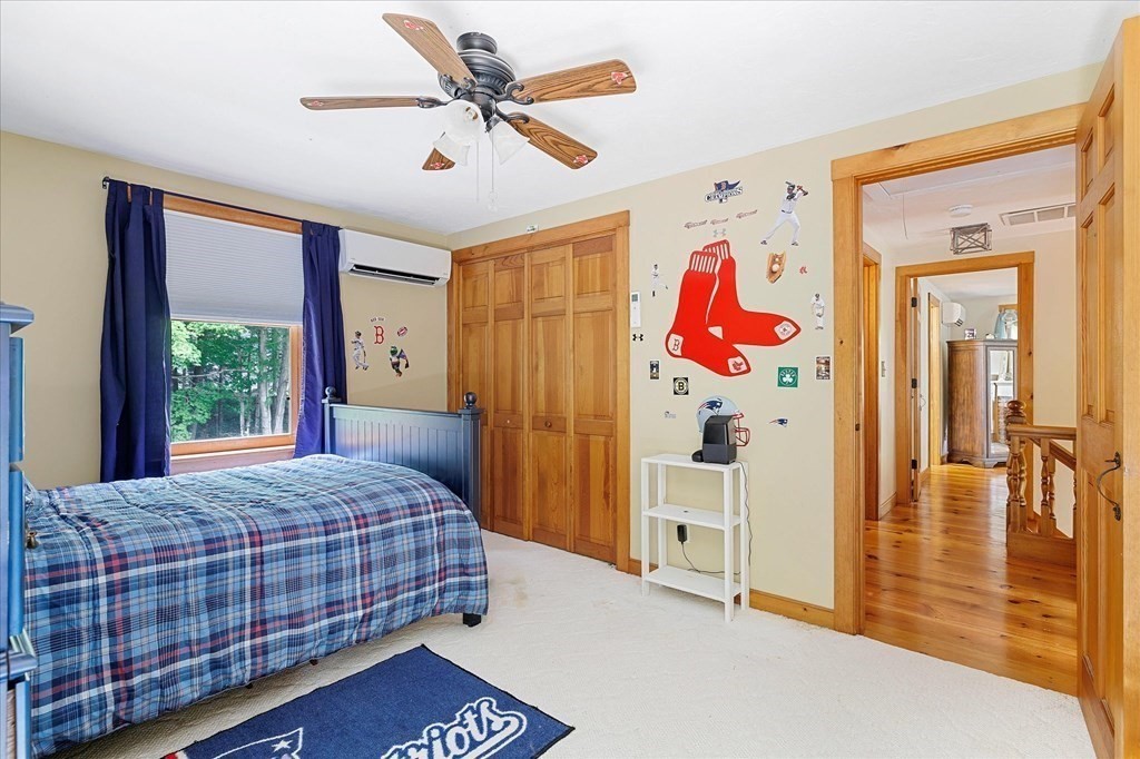 94 Stallion Hill Road Sturbridge, MA 01518 - Photo 29 of 42 a bedroom with a bed and a painting on the wall