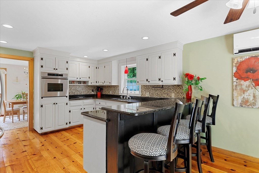 94 Stallion Hill Road Sturbridge, MA 01518 - Photo 7 of 42 a kitchen with stainless steel appliances kitchen island granite countertop a sink and cabinets