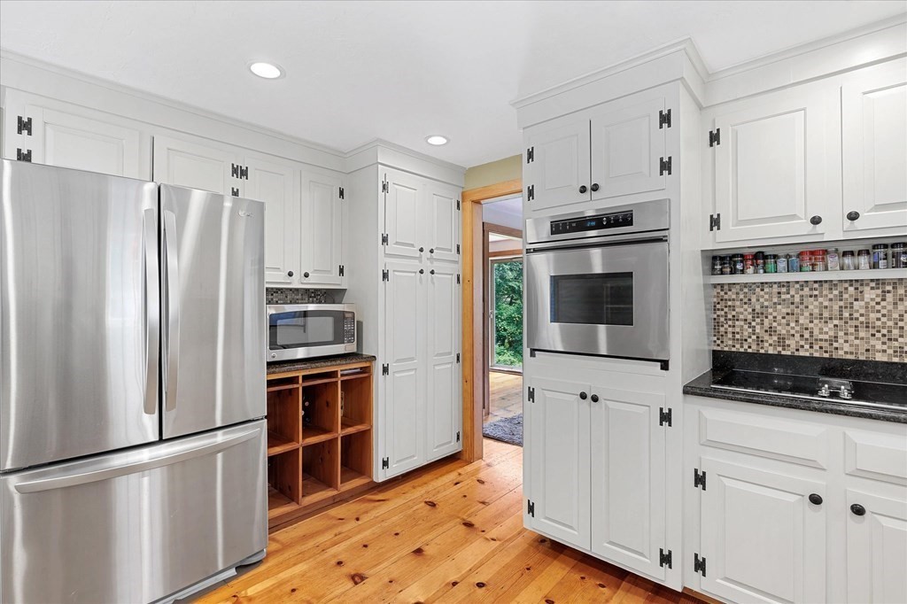 94 Stallion Hill Road Sturbridge, MA 01518 - Photo 9 of 42 a kitchen with stainless steel appliances a refrigerator stove and microwave