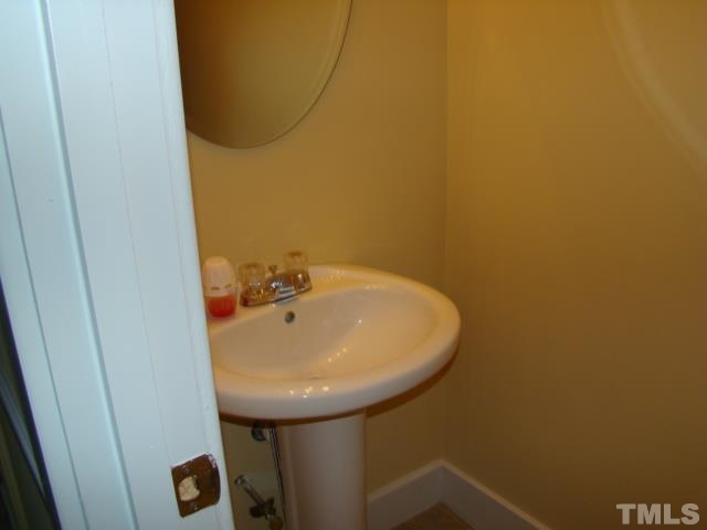 1425 Quarter Point Raleigh, NC 27615 - Photo 8 of 15 a bathroom with a sink and a mirror