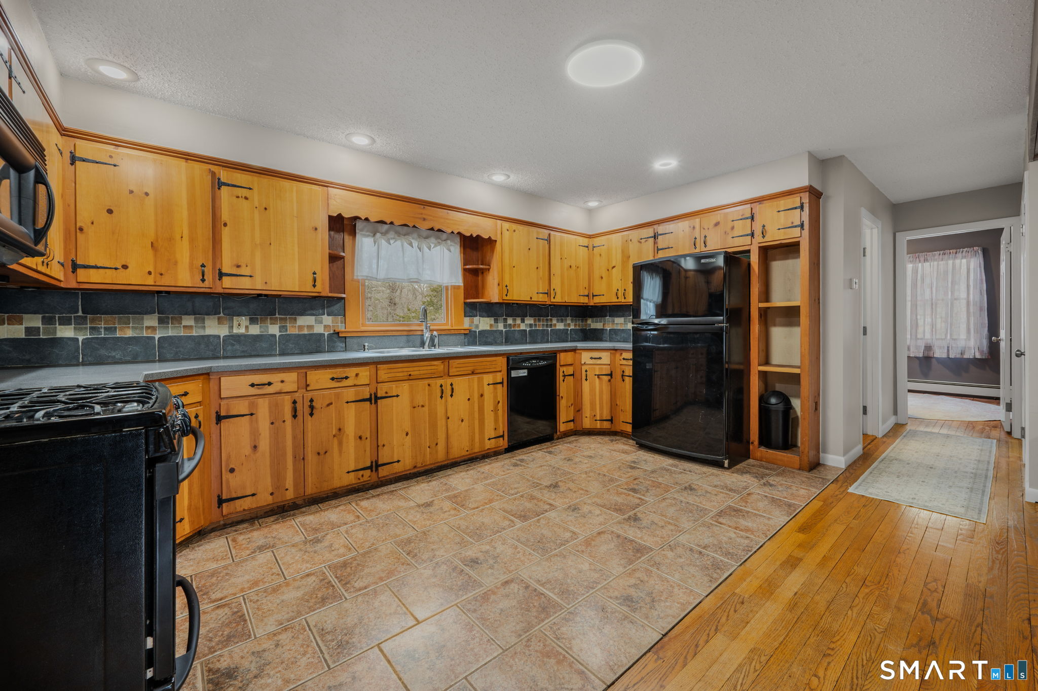 215 Haywardville Road East Haddam, CT 06415 - Photo 6 of 31 a kitchen with stainless steel appliances granite countertop a stove top oven a refrigerator and a sink