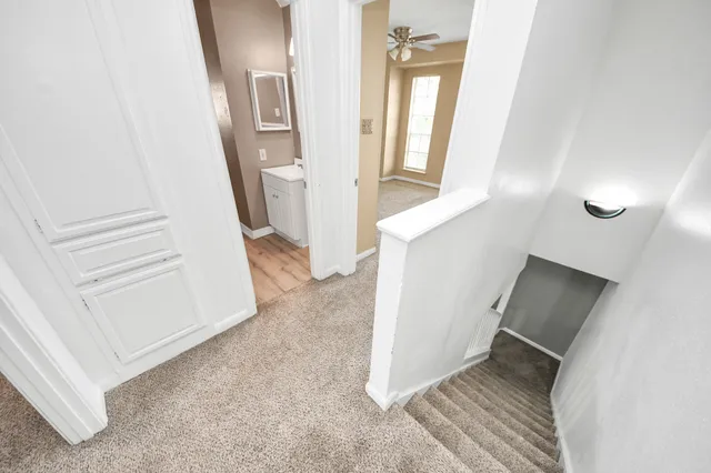 a view of a livingroom with wooden floor and stairs
