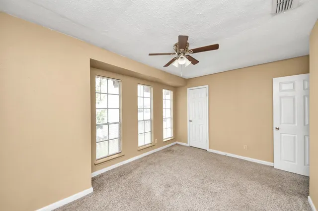 a view of a livingroom with a ceiling fan and window