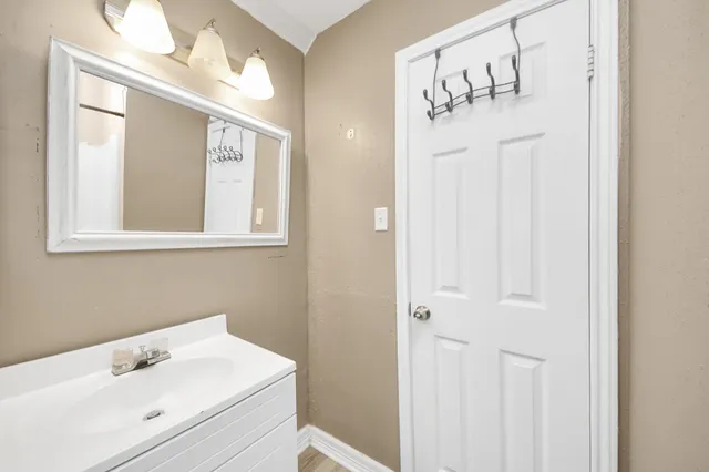 a bathroom with a sink a mirror and a shower