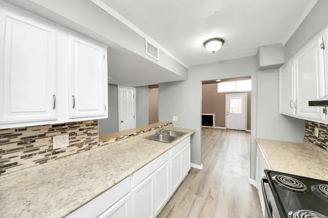 a spacious bathroom with a sink and a granite counter tops