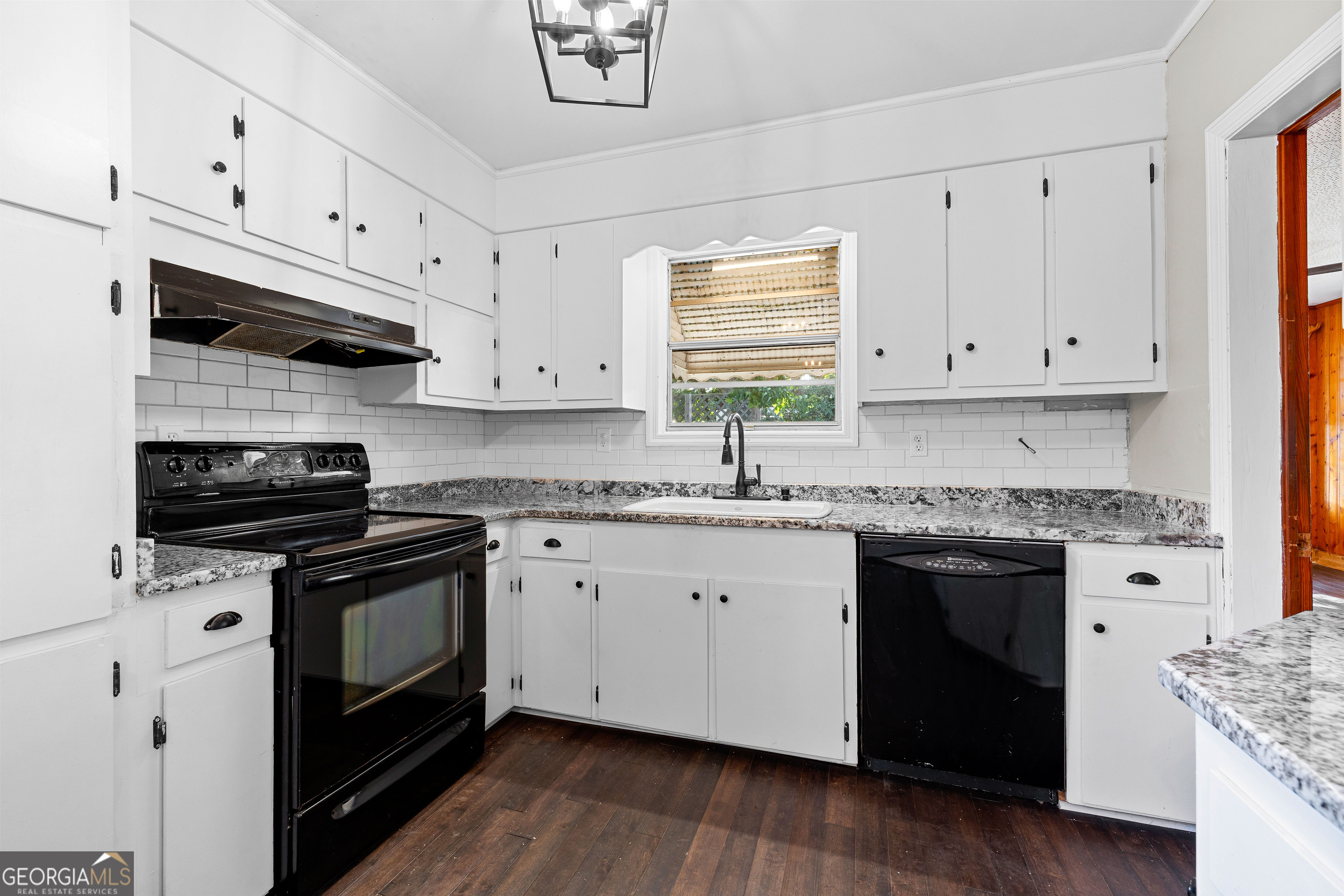 213 N Street Southwest Thomaston, GA 30286 - Photo 19 of 38 a kitchen with granite countertop white cabinets and appliances